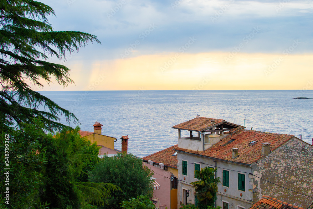 View of the horizon over the Adriatic Sea with the tiled roof of the traditional croatian houses in the old town of Rovinj, Croatia