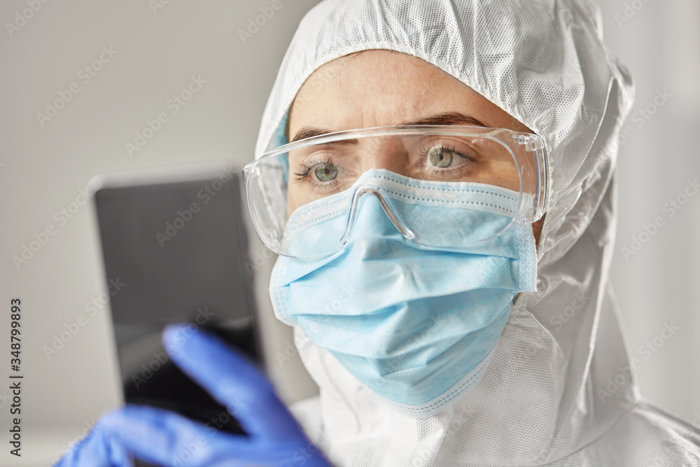 health safety, medicine and pandemic concept - close up of female doctor or scientist in protective wear, medical mask, gloves and goggles for protection from virus disease with smartphone health safety, medicine and pandemic concept - close up of female doctor or scientist in protective wear, medical mask, gloves and goggles for protection from virus disease with smartphone