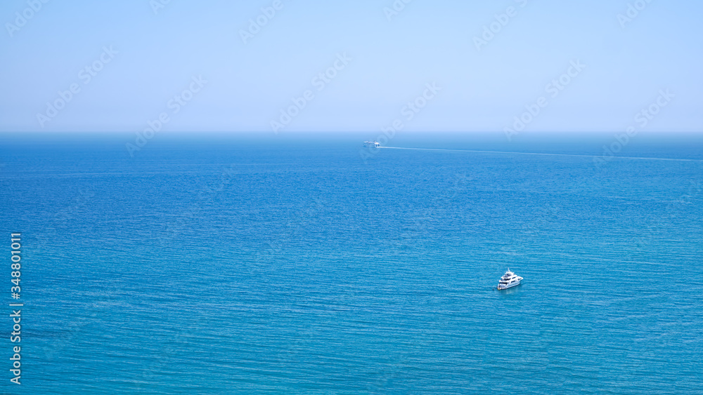 panoramic seascape of the mediterranean sea horizon with small white yacht and ferry in the distance and big open space, Malaga city, Spain panoramic seascape of the mediterranean sea horizon with small white yacht and ferry in the distance and big open space, Malaga city, Spain