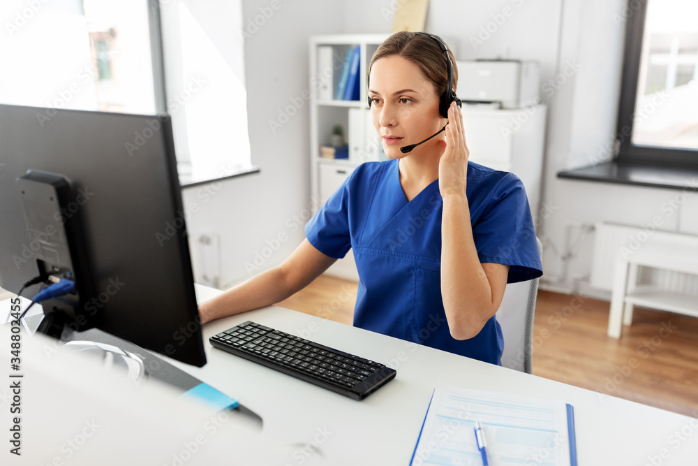 medicine, technology and healthcare concept - female doctor or nurse with headset and computer working at hospital medicine, technology and healthcare concept - female doctor or nurse with headset and computer working at hospital