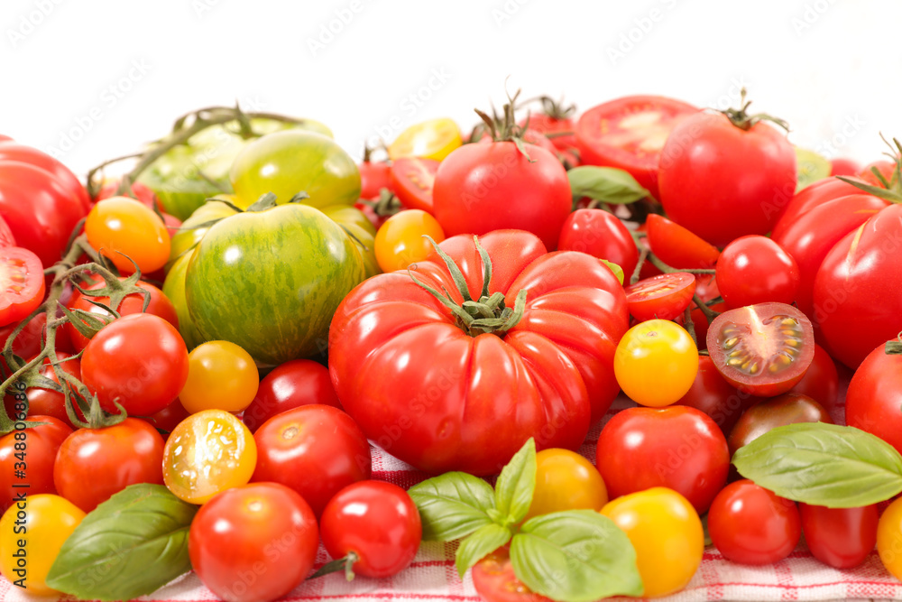 assorted of colourful tomatoes and basil