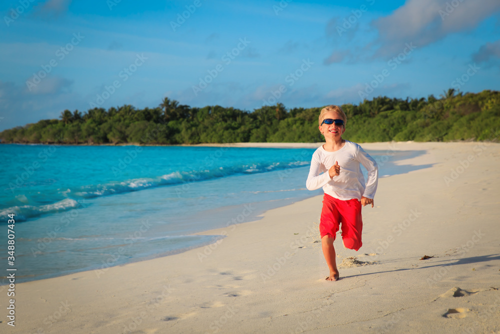 happy little boy run and play at sunset beach happy little boy run and play at sunset beach