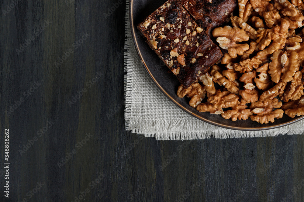 chocolate and walnut brownie next to walnuts and chocolate chocolate and walnut brownie next to walnuts and chocolate