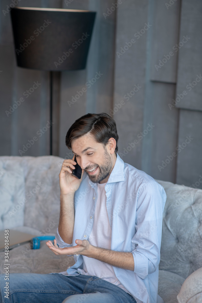 Laughing handsome man talking on a smartphone. Laughing handsome man talking on a smartphone.