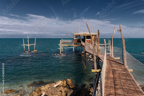 Beautiful scene of Typical fishing House on the sea. Fishing floating village on stilts, house with pier in Abruzzo.