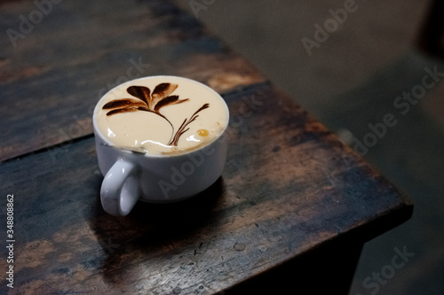 Artful egg coffee, a Vietnamese speciality, on a wooden table in a café in Hanoi