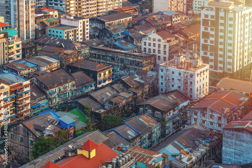 Quadro su tela 01/22/2020 Yangon, Myanmar (Burma), Aerial shot, view from the drone on the downtovn of Yangon with tiled and moss-covered houses at sunset pop colors