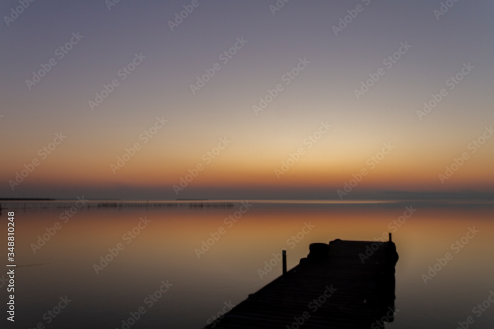 Albufera in Valencia. Dock over the lake Called Albufera with the sun going down. Beutifull golden hour with the water calm