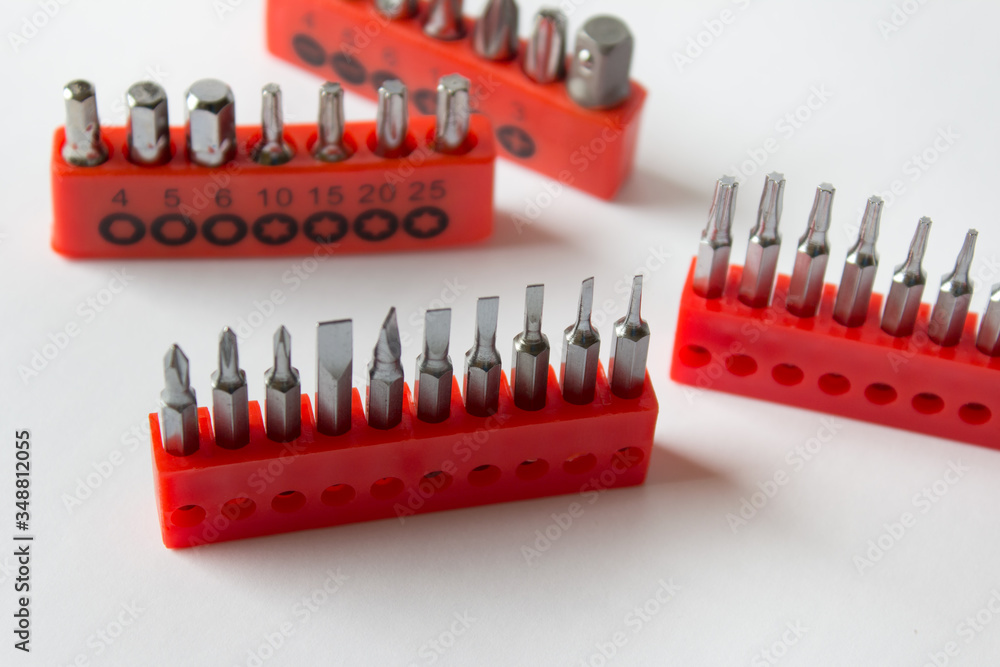 Many home electronic device repetition sets with flat and star screwdrivers on white background. Many home electronic device repetition sets with flat and star screwdrivers on white background.