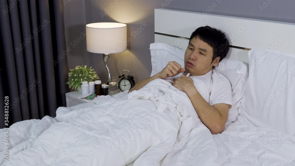 sick man tired and coughing in a bed sick man tired and coughing in a bed