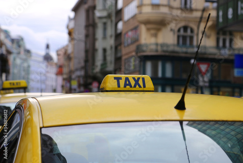 Bright yellow taxi in evening city