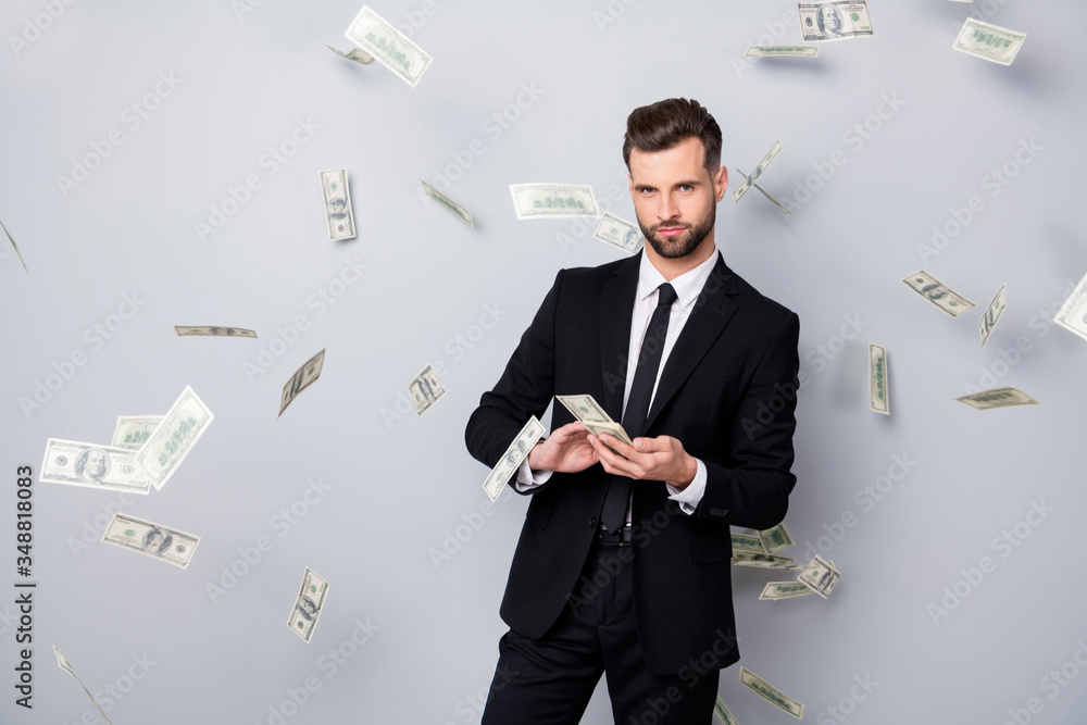 Portrait of smart confident rich company owner manager win lottery waste throw usd banknotes money fly fall wear black blazer tie jacket isolated over grey color background Portrait of smart confident rich company owner manager win lottery waste throw usd banknotes money fly fall wear black blazer tie jacket isolated over grey color background
