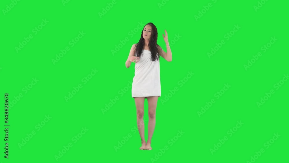Happy young beauty woman in towel laughing while talking and trying to explain. Full body pre keyed on green screen chroma key background Happy young beauty woman in towel laughing while talking and trying to explain. Full body pre keyed on green screen chroma key background