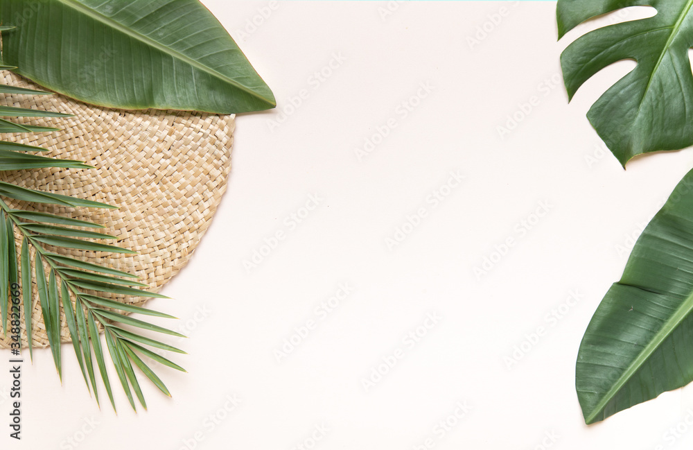 Round wicker stand and palm leaves on pink background. Fltlay style concept with text place. - obrazy, fototapety, plakaty 