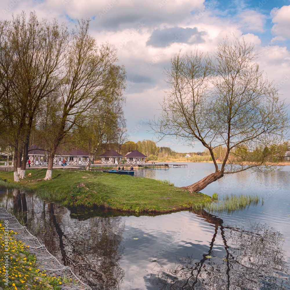 beautiful forest lake with half-timbered holiday homes against a beautiful blue sky beautiful forest lake with half-timbered holiday homes against a beautiful blue sky