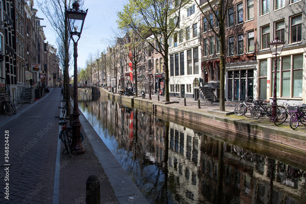 Naklejka premium The led light district zone (Hookers) Amsteram on the Oudezijdsvoorburg wal is now completely empty. There are no tourists due to the corona covid 19 virus crisis
