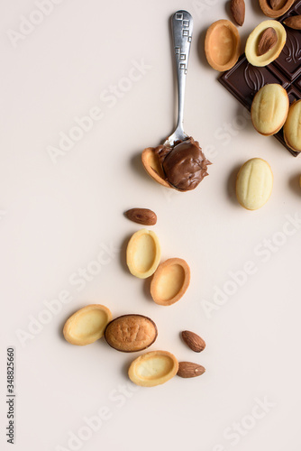 Wallpaper Mural A bar of chocolate lies on a light background with almonds, walnuts, nuts with boiled condensed milk. View from above, place for text. Flat lay Torontodigital.ca