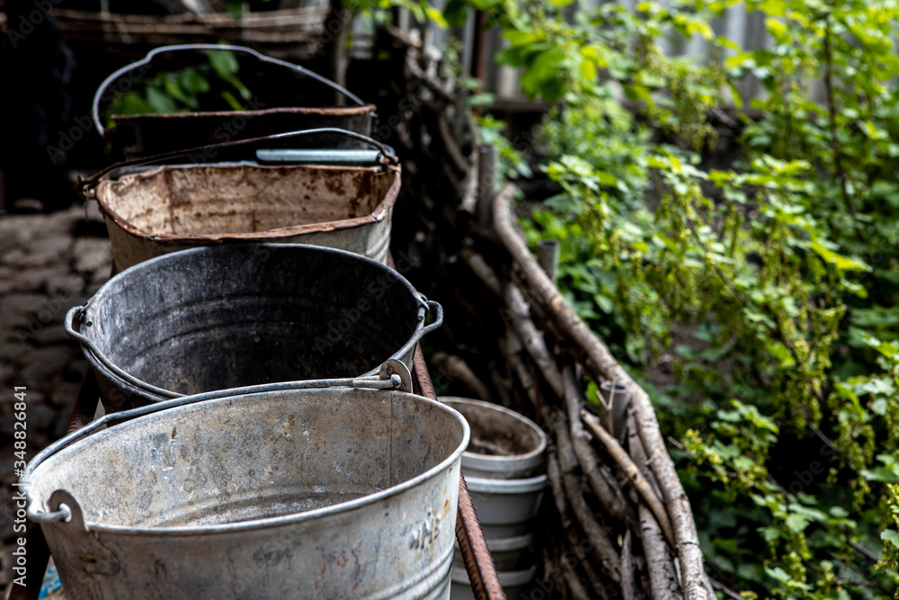 The empty old buckets are in the garden. Rural life
