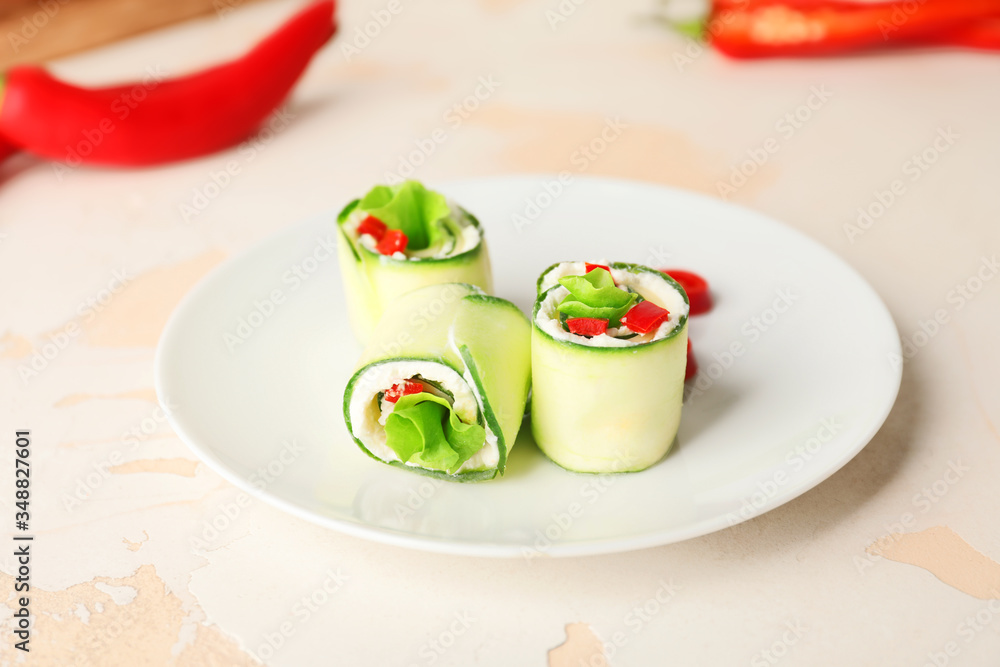 Plate with tasty cucumber rolls on white background Plate with tasty cucumber rolls on white background