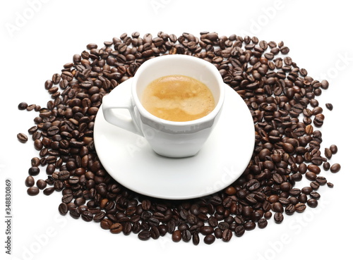 Cup of coffee and saucer with beans isolated on white background