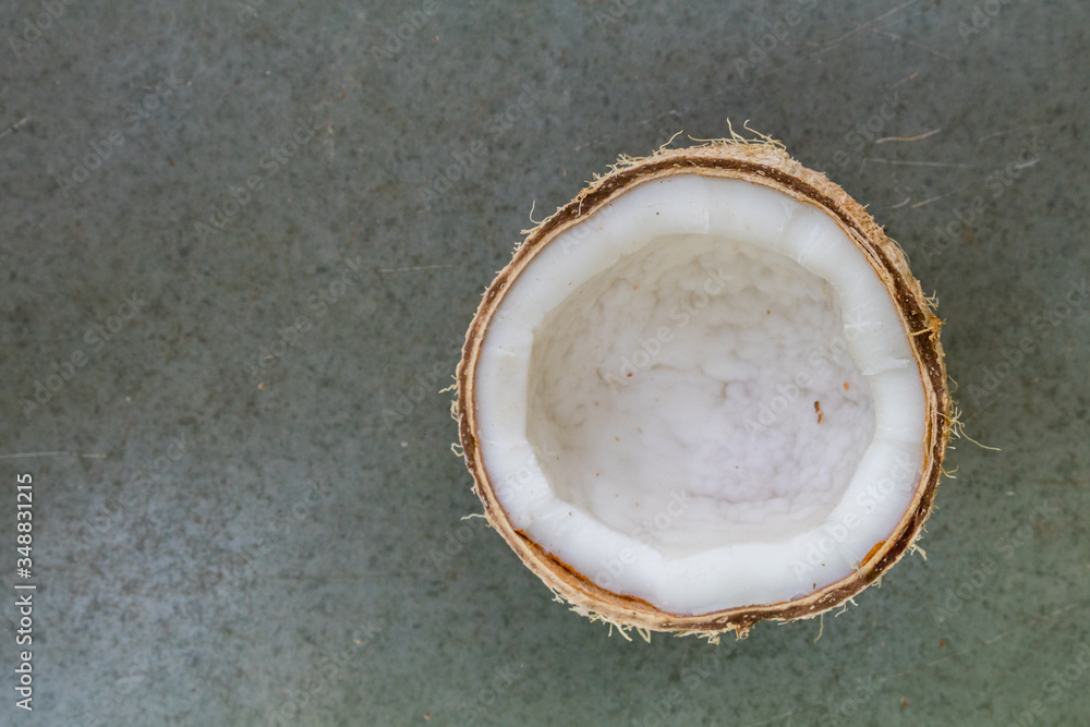 top view of a half cut coconut on plain background top view of a half cut coconut on plain background