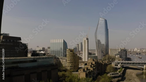 Aerial drone shot of central London from the sky, travelling forwards lowdown through tall buildings, during Covid-19 virus lockdown. Hardly any people or cars. Eery and quiet. photo