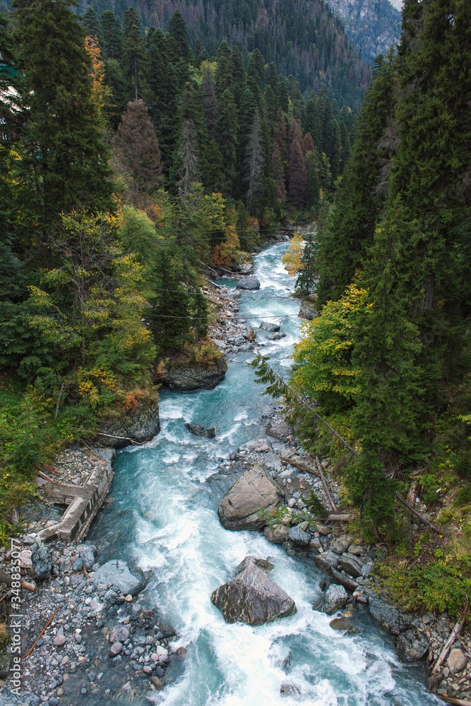 Dombay ski resort in autumn season, view on Amanaus river from the bridge in village, Caucasus, Russia Dombay ski resort in autumn season, view on Amanaus river from the bridge in village, Caucasus, Russia