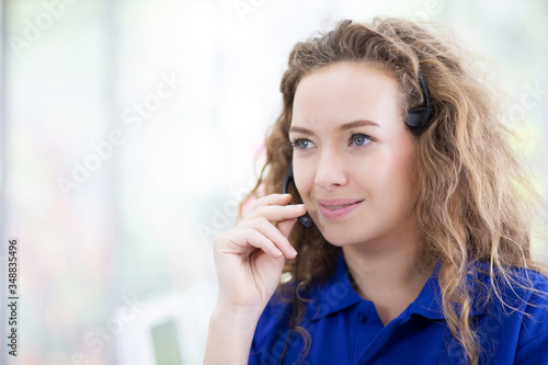 call centre. close up portrait smiling friendly Beautiful face female blue shirt operator working with headset. Technical support Customer service agent in an startup office. Contact public relations.