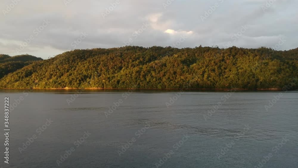 Drone, Raja Ampat, golden light on green island Drone, Raja Ampat, golden light on green island