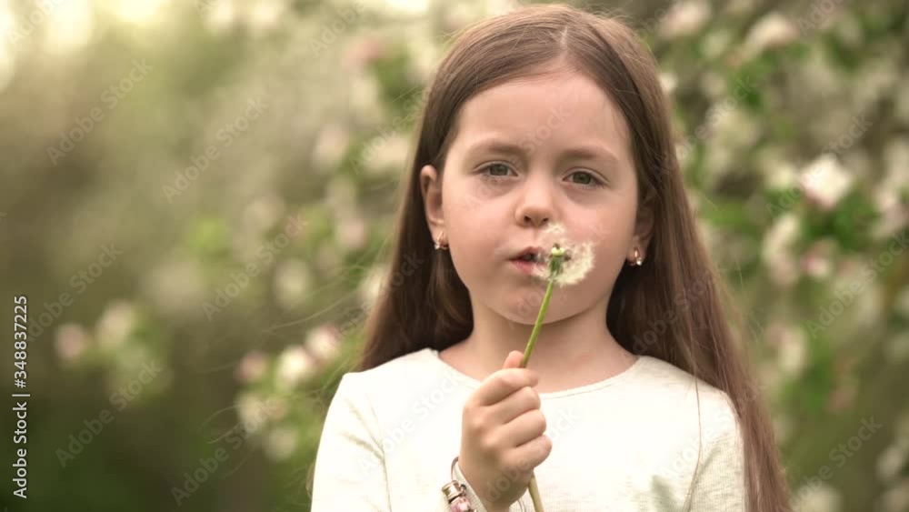 Cute little girl blow on a dandelion. Rest at nature Cute little girl blow on a dandelion. Rest at nature