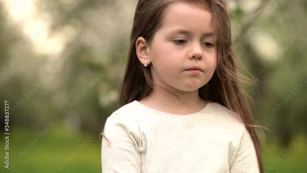 portrait beautiful little girl smiling looking happy cute child having fun in sunny park outdoors, enjoying childhood. 4k footage portrait beautiful little girl smiling looking happy cute child having fun in sunny park outdoors, enjoying childhood. 4k footage