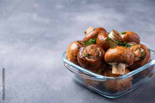 Champignon mushrooms marinated with olive oil and fennel ready to cook. Mushrooms reday to bbq. Text space photo