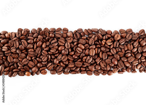 Roasted coffee beans on a white background. The texture of the coffee. An invigorating drink.