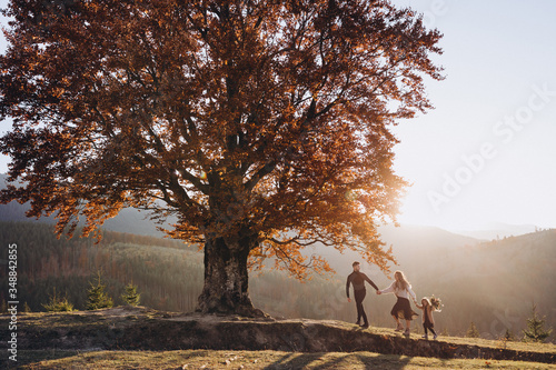 Принти на полотні Stylish young family in the autumn mountains