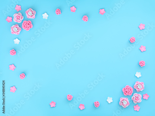 Pink and white flowers made of foamiran on blue background with beads. Mother day, Valentine day, Wedding, Birthday concept. Greeting or invitation card. Flat lay with copy space.