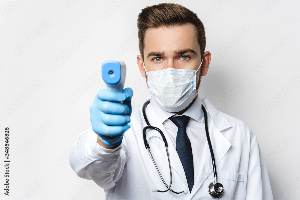 Doctor is measuring body temperature with a infrared thermometer Doctor is measuring body temperature with a infrared thermometer