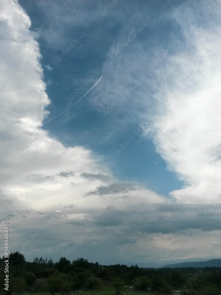stormy clouds over green forest in summer season stormy clouds over green forest in summer season