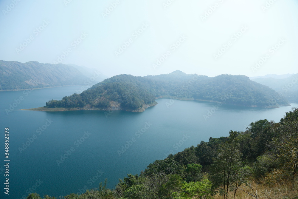 Misty morning mountain in a dam.
