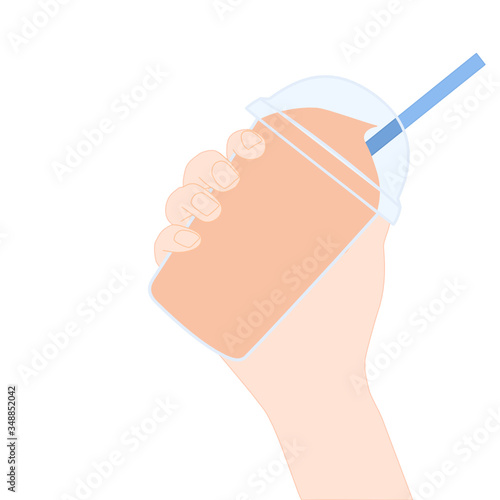 Hand is holding​ a orange smoothie. A cold soft drink for summer. Sweet beverage. Tasty and yummy food. A takeaway Product logo or advertisement.