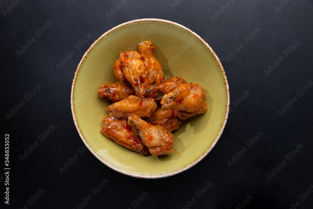 fried chicken legs in a plate on a dark background fried chicken legs in a plate on a dark background