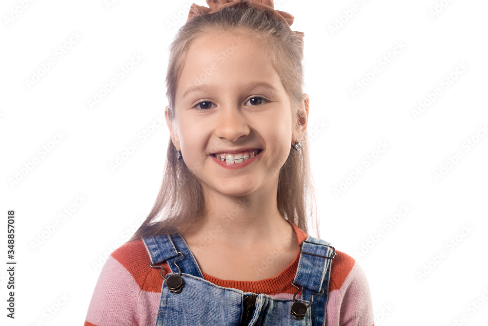 Little girl with orthodontics appliance isolated on white background. Little girl with orthodontics appliance isolated on white background.