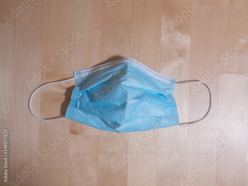 surgical mask on wooden table protection for coronavirus