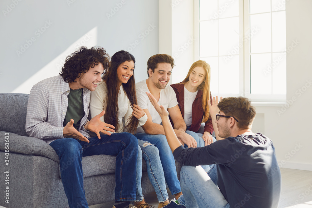 A group of friends talking in a room. A group of friends talking in a room.
