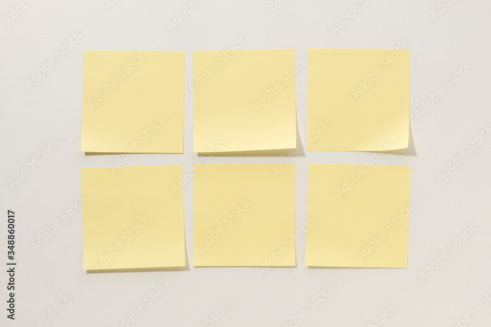 Fototapeta premium Yellow Sticky Notes on a White Background