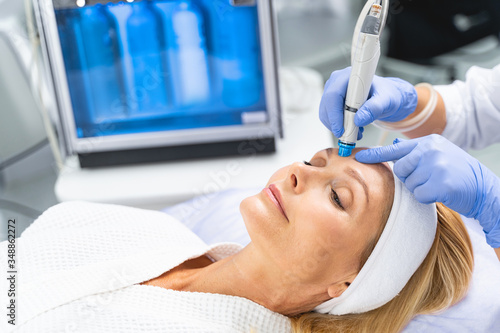 Konstfotografi Female patient undergoing a facial hydrodermabrasion treatment