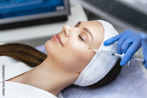 Pleased female patient during the mesotherapy procedure