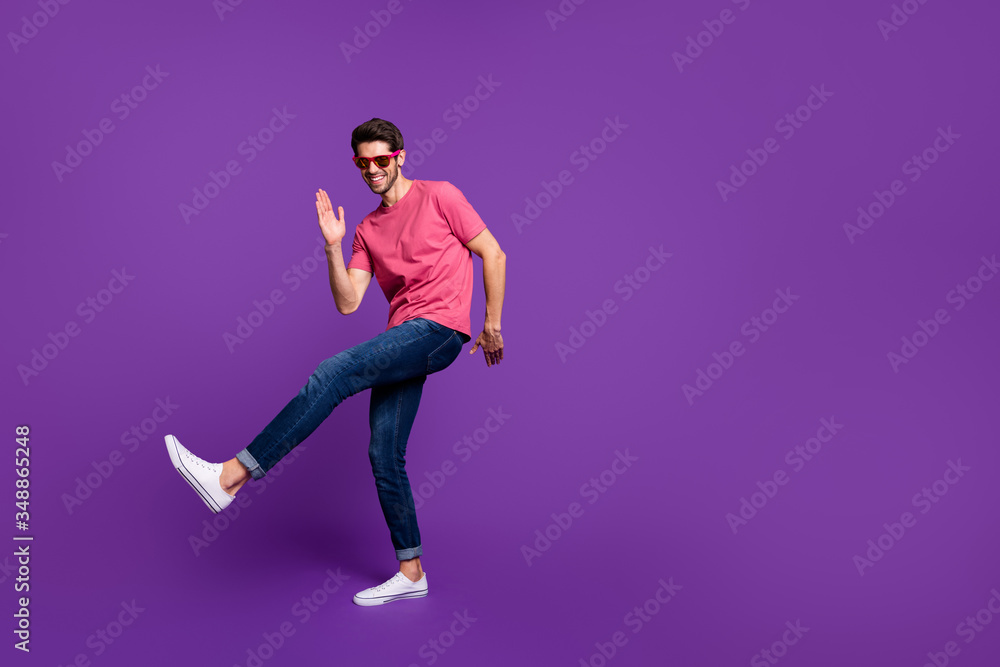 Full size photo of cheerful candid funny guy dance discotheque enjoy music night club wear good look outfit gumshoes isolated over purple shine color background