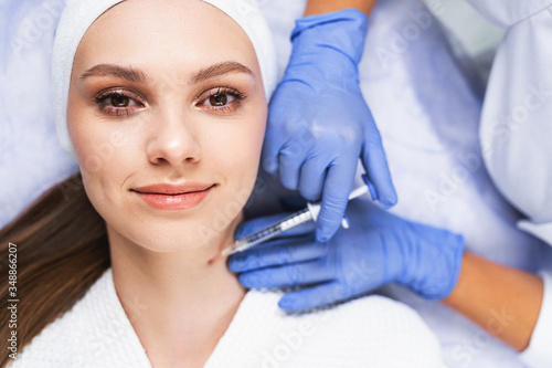 Serene woman smiling during the mesotherapy procedure