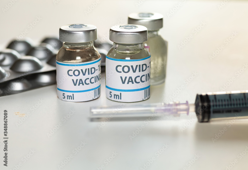 Coronavirus preventive drugs with vaccine bottles and injection syringe shot in selective focus Coronavirus preventive drugs with vaccine bottles and injection syringe shot in selective focus