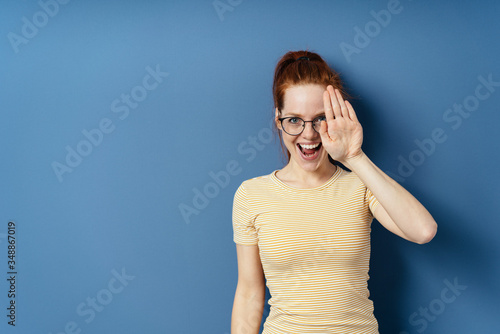 Vivacious young woman holding up her hand © contrastwerkstatt